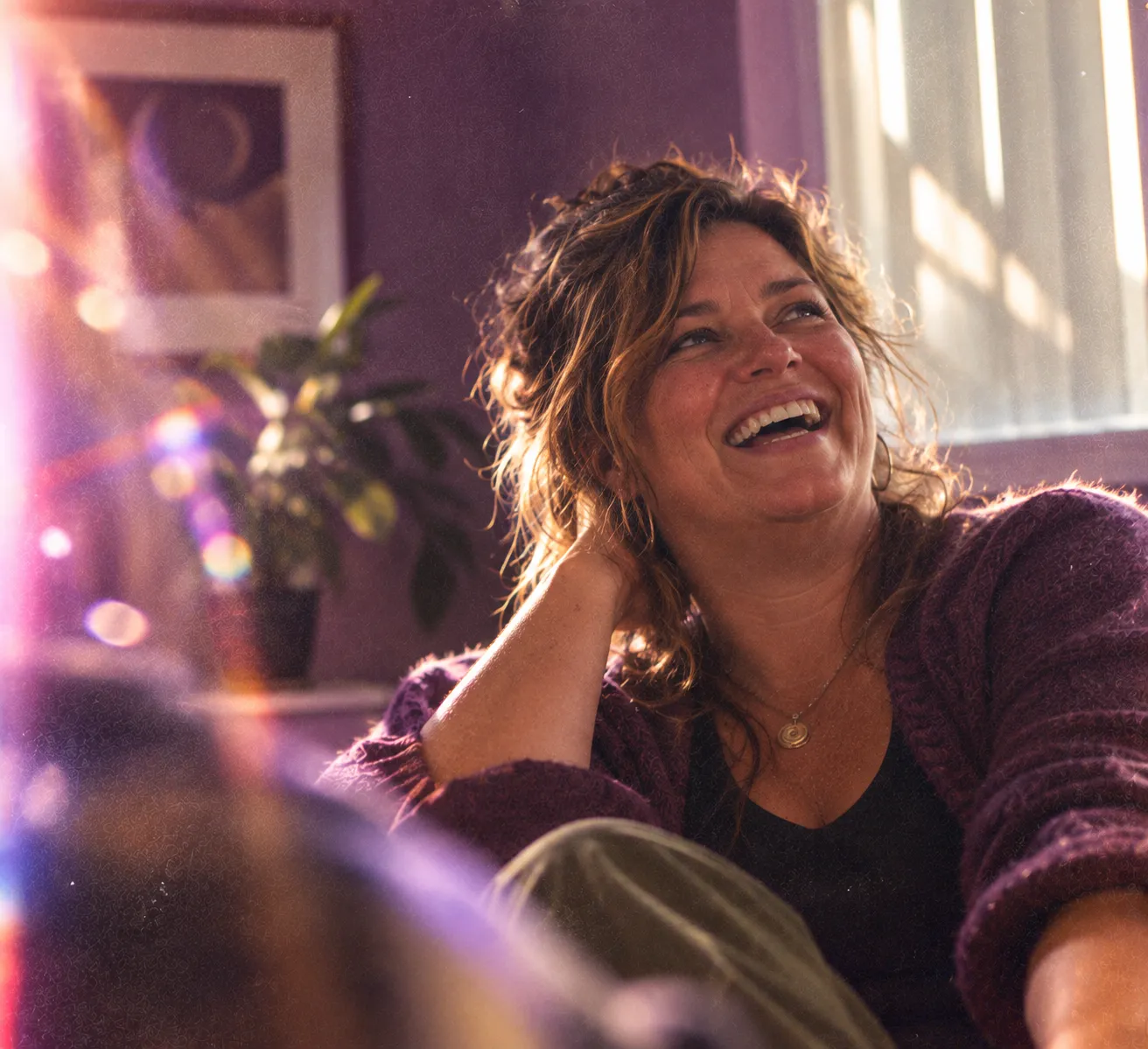 A woman laughing during a first conversation